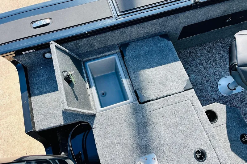 Slide: The Image of 2026 Tracker Targa V-18 Combo boat interior with open storage compartment and seating. - 62