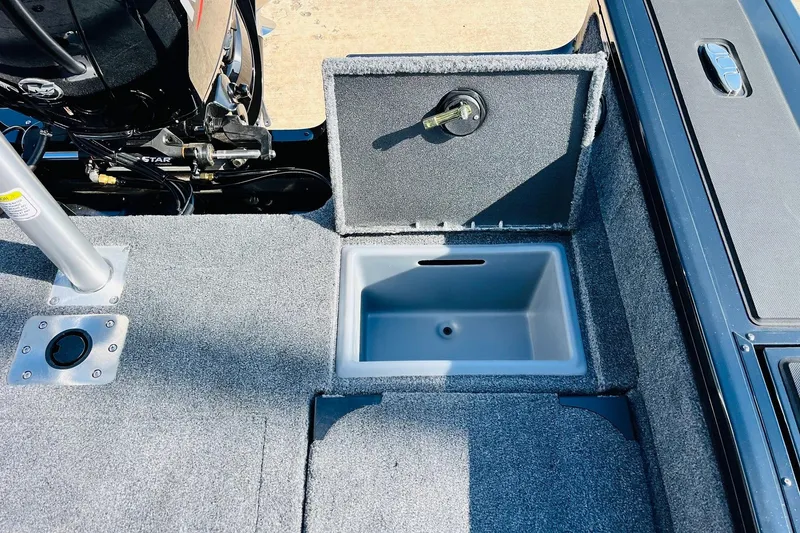 Slide: The Image of 2026 Tracker Targa V-18 Combo boat interior with open storage compartment. - 63