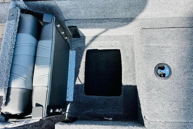 Slide: The Image of 2026 Tracker Targa V-18 Combo boat interior with folded seats and storage compartment. - 66
