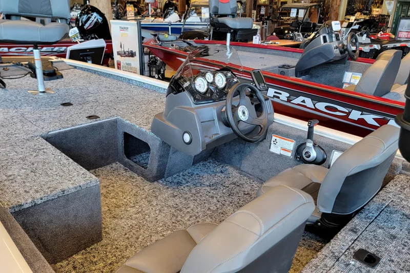 Slide: The Image of 2026 Tracker Pro 170 boat interior with steering console and seating. - 2