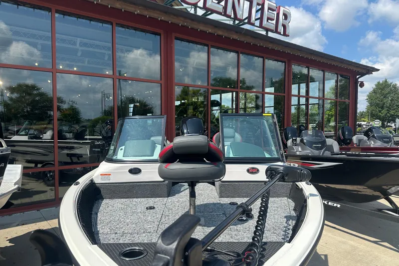 Slide: The Image of 2025 Ranger VS1682SC Reata boat displayed outside a showroom on a sunny day. - 3