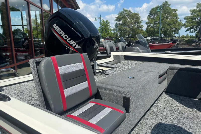 Slide: The Image of 2025 Ranger VS1682SC Reata boat interior with Mercury engine, featuring gray and red seating. - 4