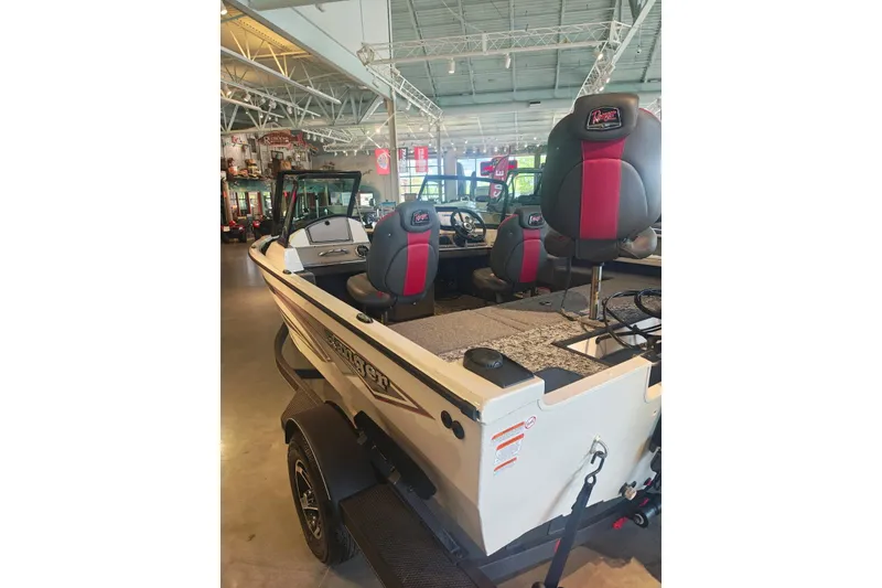 Slide: The Image of 2025 Ranger VS1682SC Reata boat displayed in a showroom, featuring sleek seating and modern design. - 9