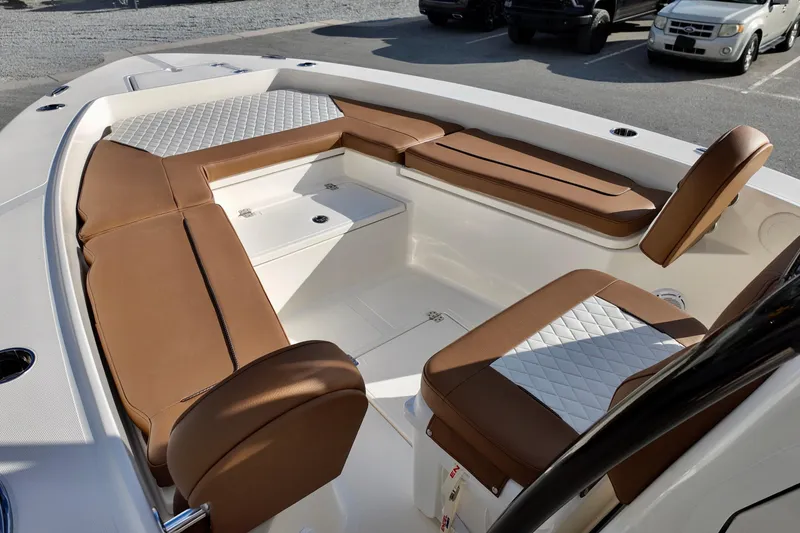 Slide: The Image of 2026 Pioneer 220 Baysport boat interior with brown and white cushioned seating. - 5