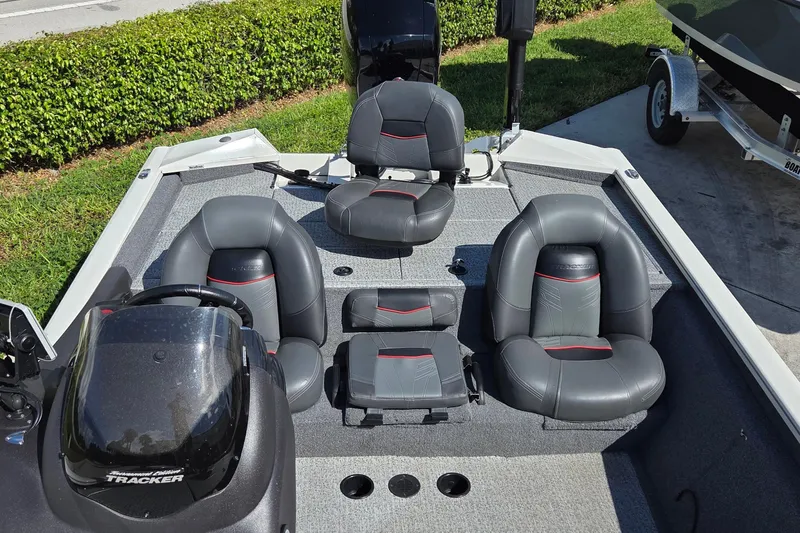 Slide: The Image of 2023 Tracker Pro Team 195 TXW Tournament Edition boat interior with gray and black seating. - 12