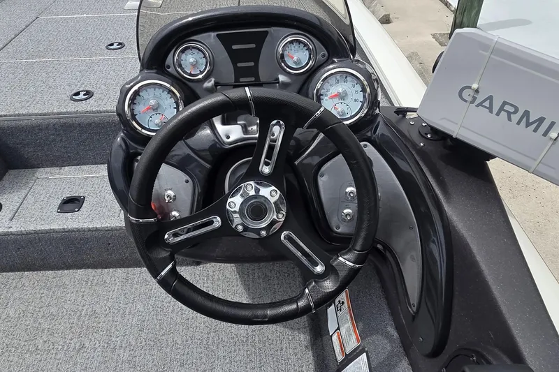 Slide: The Image of 2023 Tracker Pro Team 195 TXW Tournament Edition boat dashboard with steering wheel and Garmin display. - 16