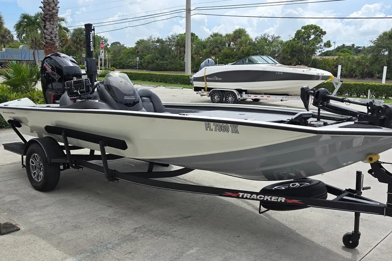 Slide: The Image of 2023 Tracker Pro Team 195 TXW Tournament Edition boat on trailer, parked outdoors. - 3