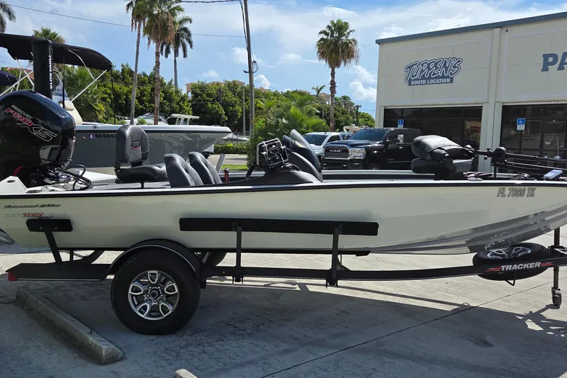Slide: The Image of 2023 Tracker Pro Team 195 TXW Tournament Edition boat on trailer, parked outdoors. - 4