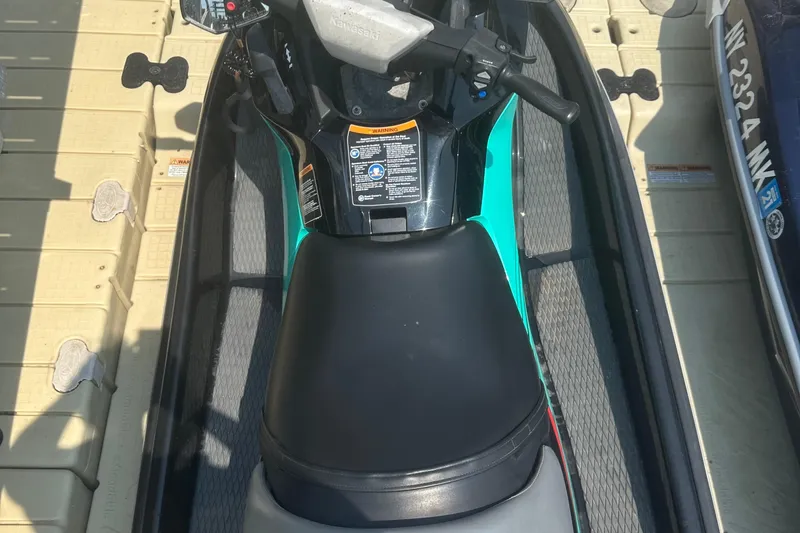 Slide: The Image of 2021 Kawasaki Jetski STX 160X in teal and black on a dock. - 7