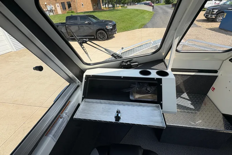 Slide: The Image of Interior view of 2026 Lund 210 HG boat with open storage compartment. - 20