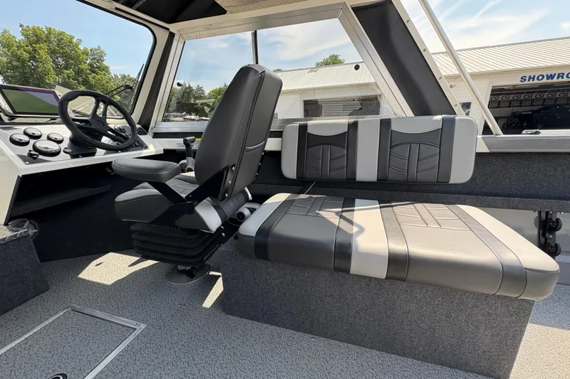 Slide: The Image of Interior of 2026 Lund 210 HG boat with steering wheel and seating. - 23
