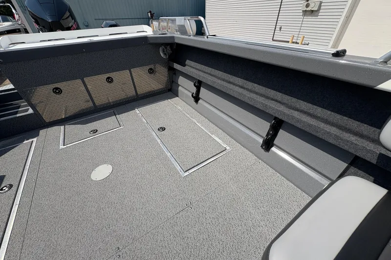 Slide: The Image of 2026 Lund 210 HG boat interior with storage compartments and seating. - 29