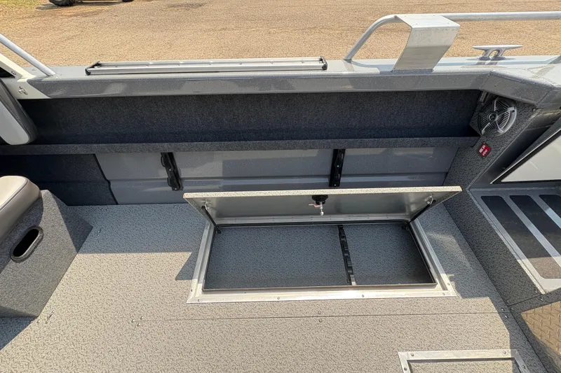 Slide: The Image of 2026 Lund 210 HG boat interior with open storage compartment on deck. - 33