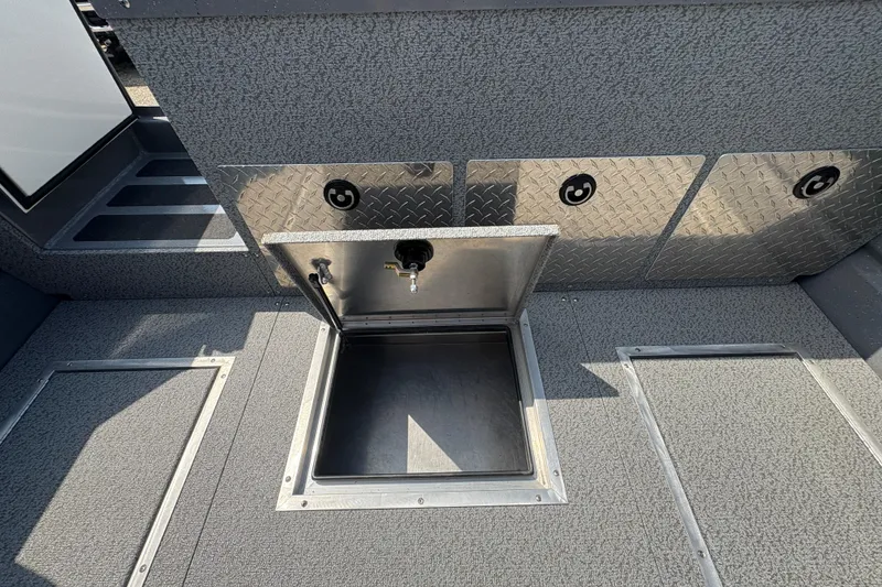 Slide: The Image of 2026 Lund 210 HG boat storage compartment with open hatch, showcasing interior space. - 35