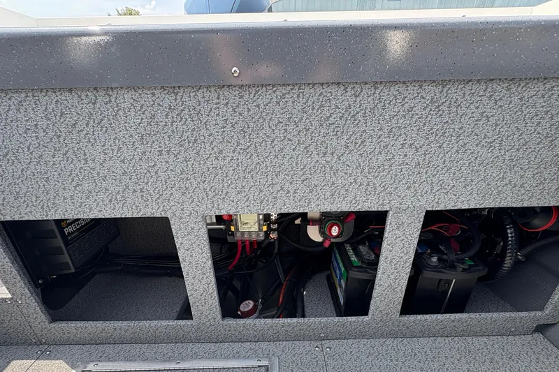 Slide: The Image of Interior view of 2026 Lund 210 HG boat showing battery compartment and wiring. - 36