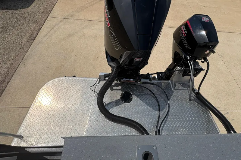 Slide: The Image of 2026 Lund 210 HG boat with dual outboard motors on a metal platform. - 42