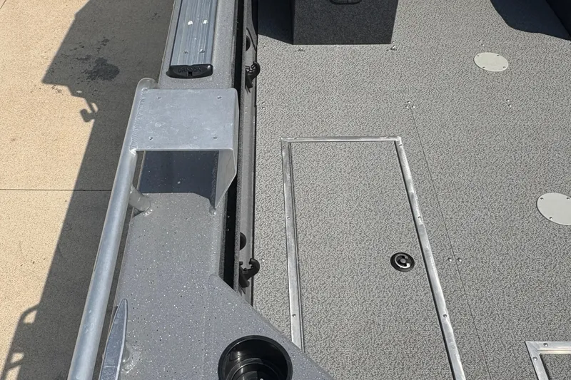 Slide: The Image of 2026 Lund 210 HG boat interior with textured flooring and storage compartments. - 45