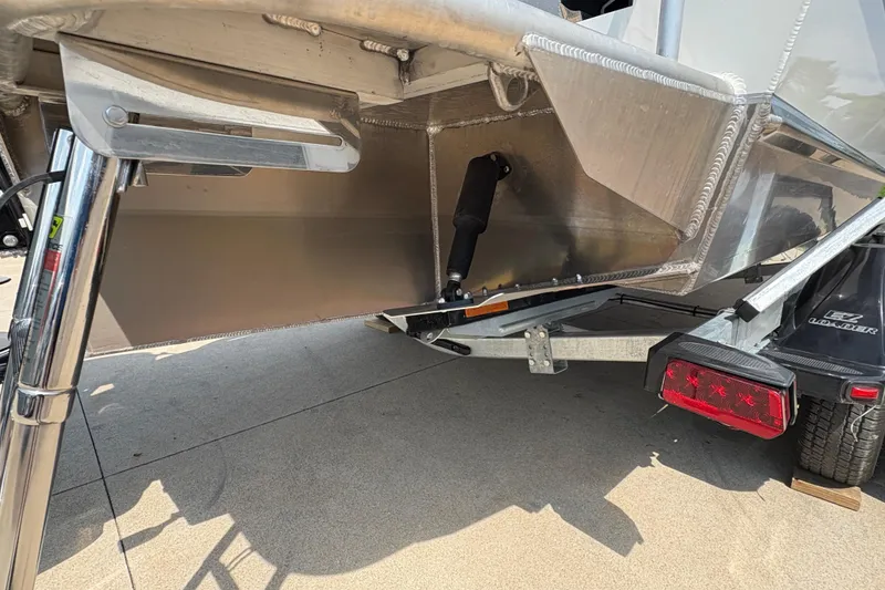 Slide: The Image of 2026 Lund 210 HG boat trailer with hydraulic system and rear light assembly. - 47