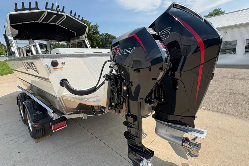 Slide: The Image of 2026 Lund 210 HG boat with dual Mercury outboard motors on a trailer. - 48