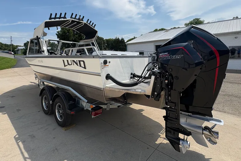 Slide: The Image of 2026 Lund 210 HG boat on trailer with powerful Mercury outboard motor. - 5
