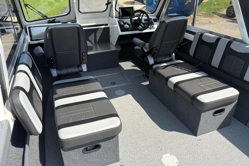 Slide: The Image of 2026 Lund 210 HG boat interior with modern seating and control panel. - 55