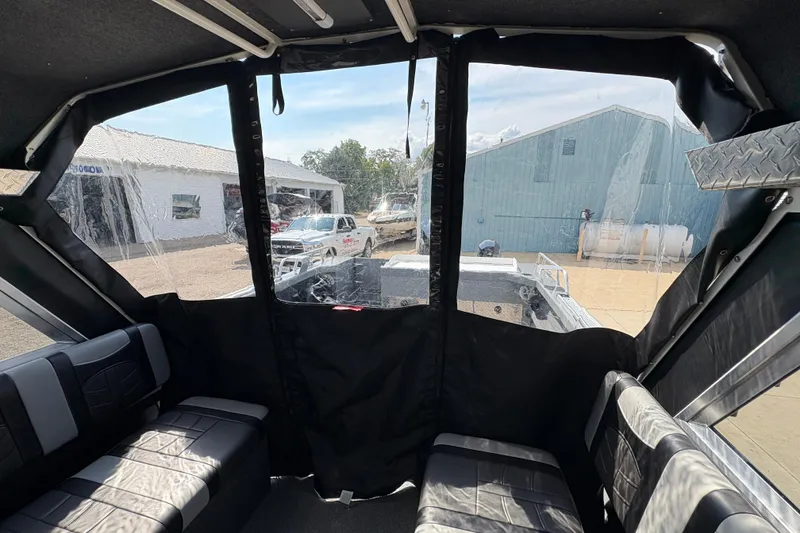 Slide: The Image of Interior view of 2026 Lund 210 HG boat with covered seating area. - 57