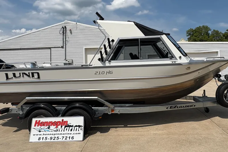 Slide: The Image of 2026 Lund 210 HG boat on trailer at Hennepin Marine dealership. - 9