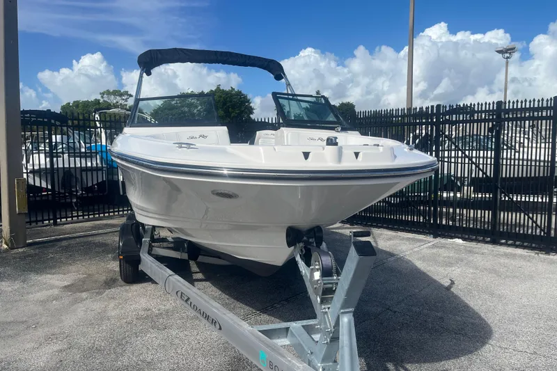 Slide: The Image of 2022 Sea Ray SPX 210 Outboard boat on trailer, parked outdoors. - 4