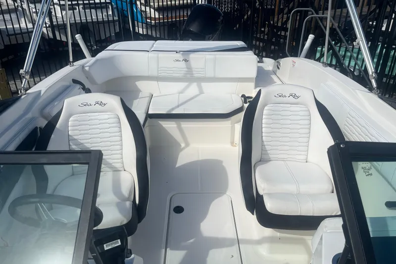 Slide: The Image of 2022 Sea Ray SPX 210 Outboard boat interior with white seating and steering wheel. - 5