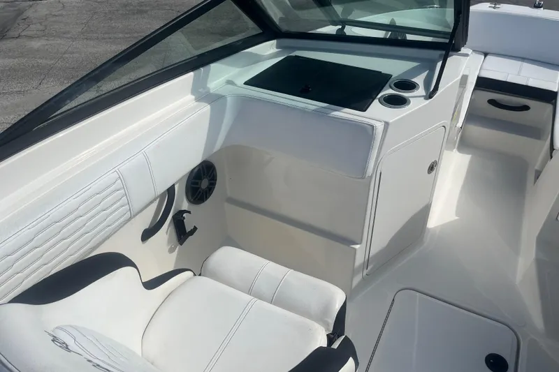 Slide: The Image of 2022 Sea Ray SPX 210 Outboard interior with white seating and dashboard details. - 7