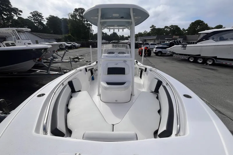 Slide: The Image of 2024 Tidewater 210 LXF boat with spacious seating, parked in a marina. - 10