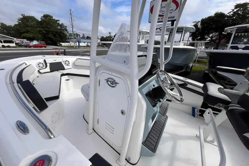 Slide: The Image of 2024 Tidewater 210 LXF boat interior with steering console and seating area. - 12