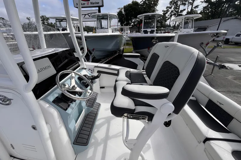 Slide: The Image of 2024 Tidewater 210 LXF boat interior with steering wheel and seating. - 13