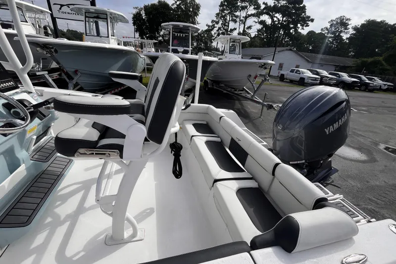Slide: The Image of 2024 Tidewater 210 LXF boat interior with Yamaha engine, featuring seating and control area. - 15