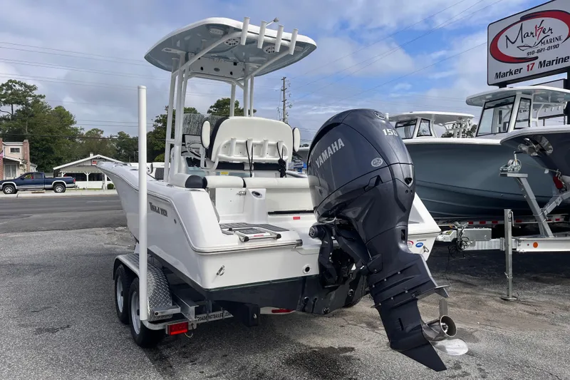 Slide: The Image of 2024 Tidewater 210 LXF boat with Yamaha engine, displayed at a marine dealership. - 2