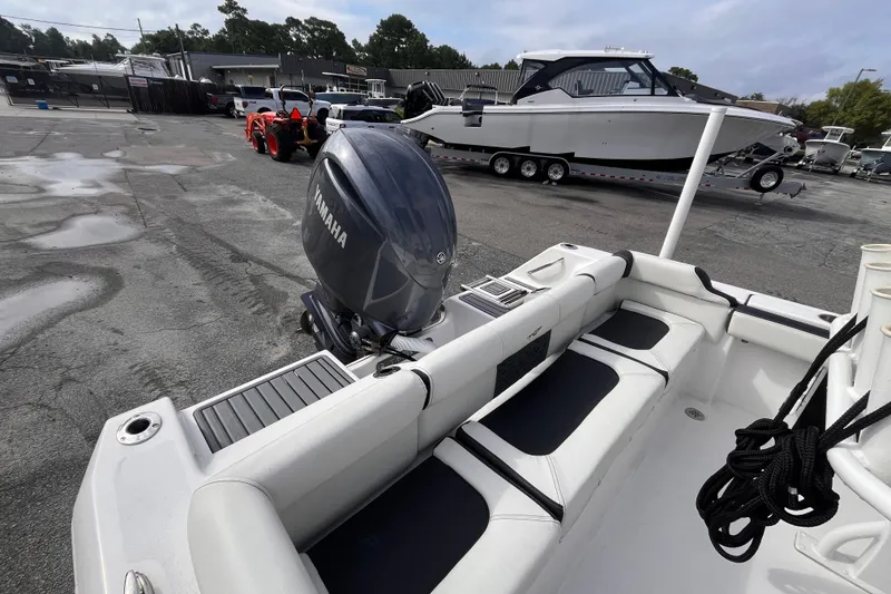 Slide: The Image of 2024 Tidewater 210 LXF boat with Yamaha engine, parked in a marina. - 5