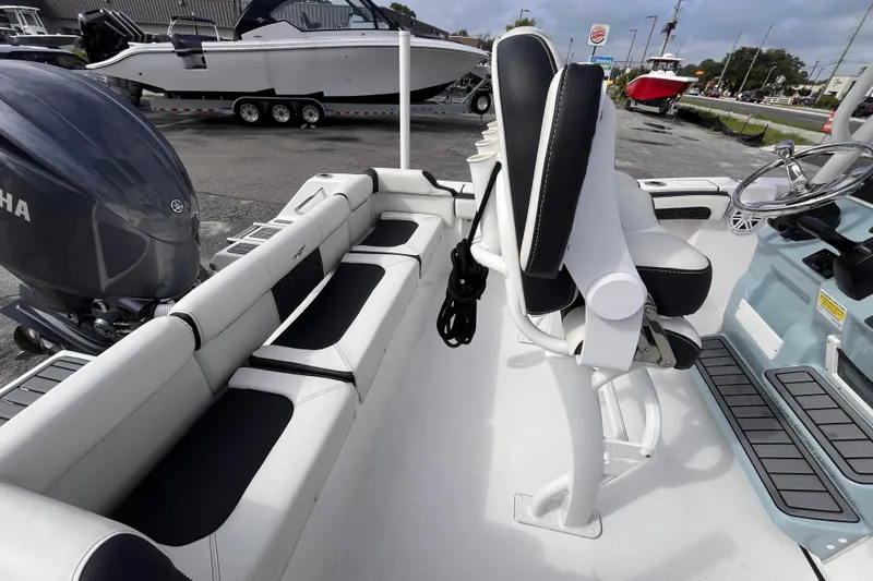 Slide: The Image of 2024 Tidewater 210 LXF boat interior with seating and Yamaha engine. - 6