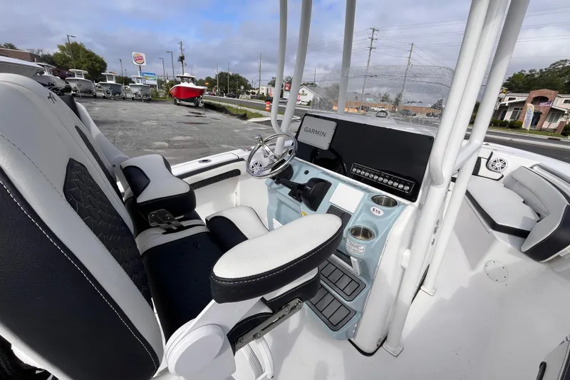 Slide: The Image of 2024 Tidewater 210 LXF boat interior with Garmin navigation system and modern seating. - 7