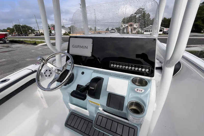 Slide: The Image of 2024 Tidewater 210 LXF boat console with Garmin navigation and steering wheel. - 8
