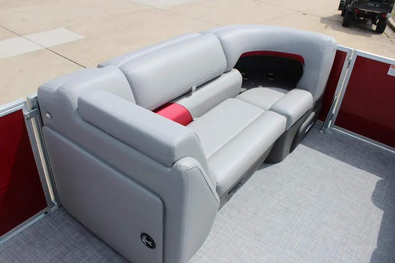 Slide: The Image of 2026 Sun Tracker Party Barge 20 DLX interior with gray seating and red accents. - 12