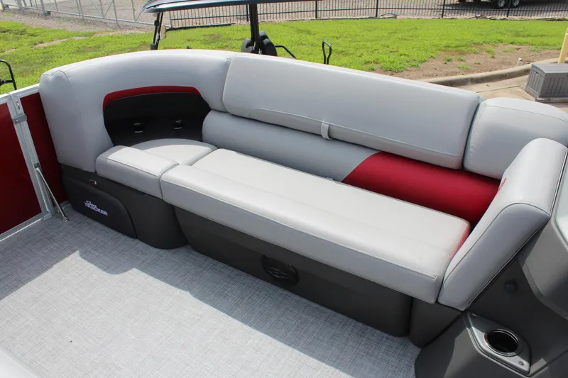 Slide: The Image of 2026 Sun Tracker Party Barge 20 DLX interior seating with gray and red upholstery. - 13
