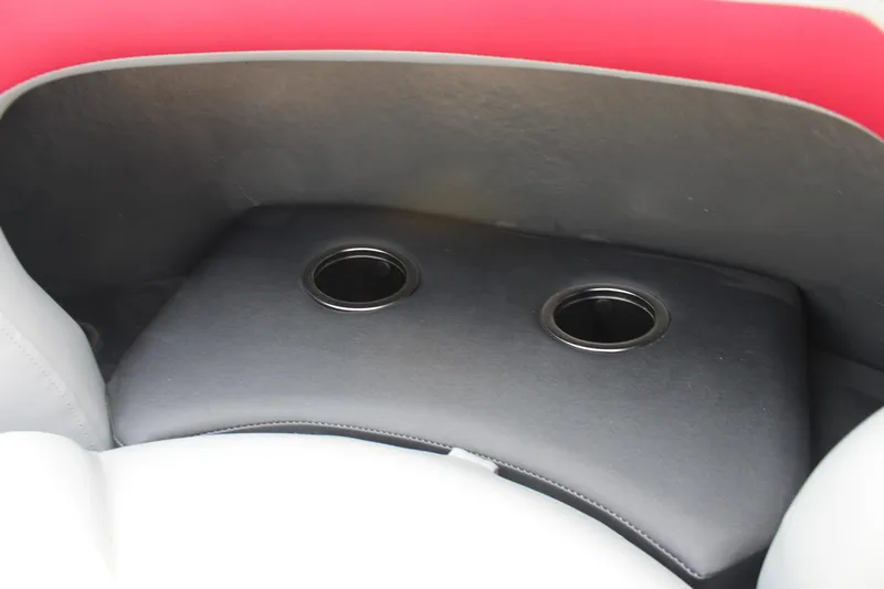 Slide: The Image of 2026 Sun Tracker Party Barge 20 DLX cup holders in cushioned seating area. - 14