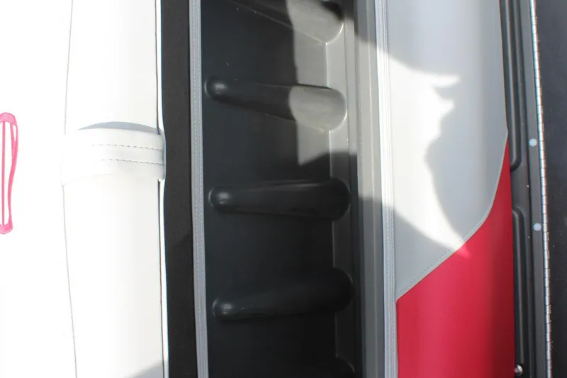 Slide: The Image of 2026 Sun Tracker Party Barge 20 DLX interior seating with red and white upholstery. - 18