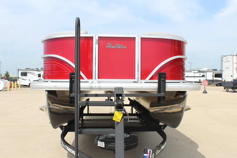 Slide: The Image of 2026 Sun Tracker Party Barge 20 DLX pontoon boat, red exterior, parked on trailer. - 2