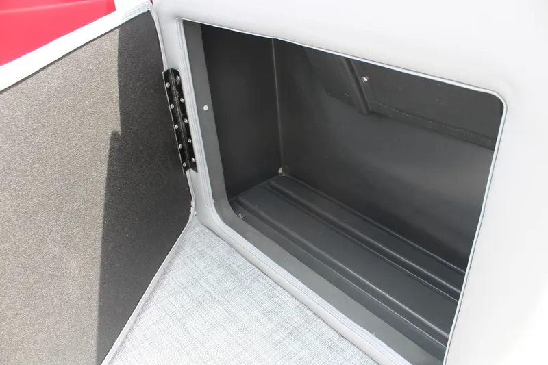 Slide: The Image of 2026 Sun Tracker Party Barge 20 DLX storage compartment, open and empty. - 21