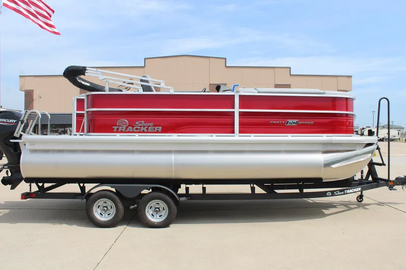 Slide: The Image of 2026 Sun Tracker Party Barge 20 DLX pontoon boat on trailer, red and silver design. - 4