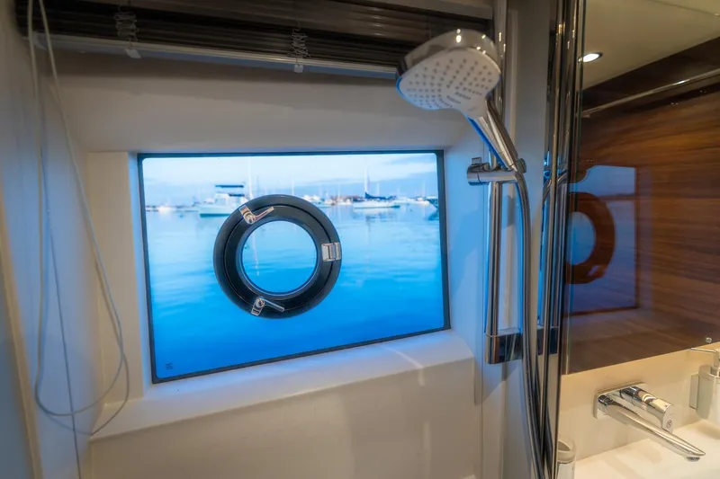 Slide: The Image of Interior of 2026 Princess V55 Express yacht with sofa and window view. - 31