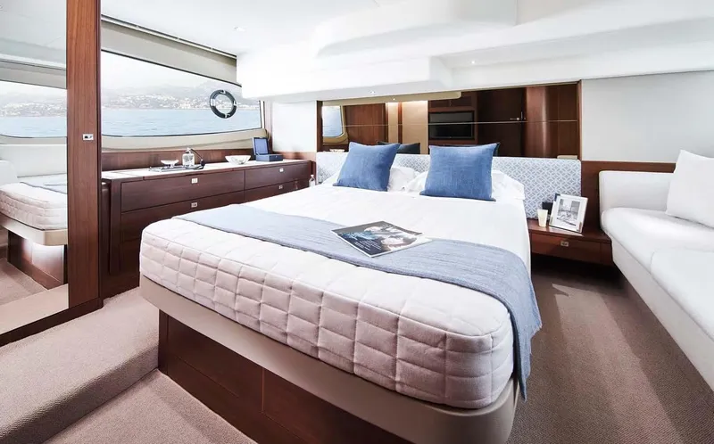 Slide: The Image of Luxurious 2025 Princess 50 Flybridge yacht bedroom with elegant decor and scenic window view. - 13
