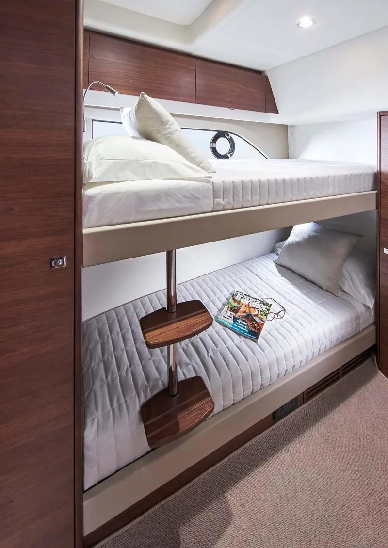 Slide: The Image of 2025 Princess 50 Flybridge yacht cabin with bunk beds and modern design. - 16