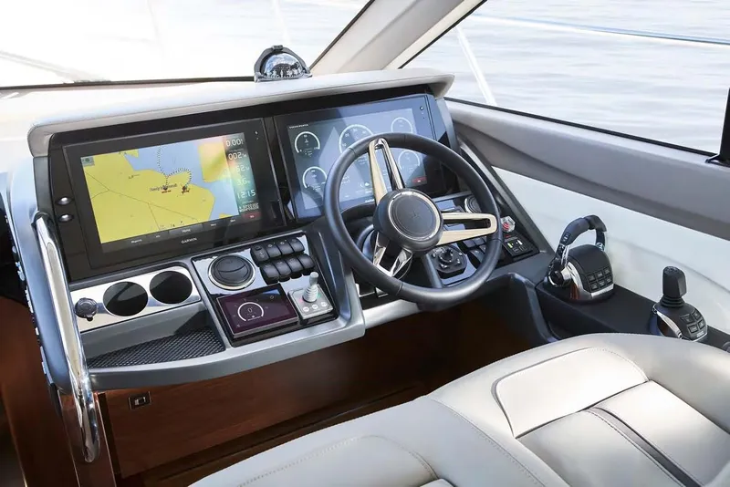 Slide: The Image of 2025 Princess 50 Flybridge yacht helm with advanced navigation system and luxurious seating. - 9